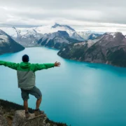Man outside looking at mountain scene