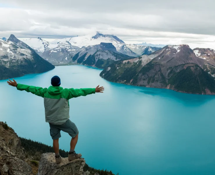 Man outside looking at mountain scene