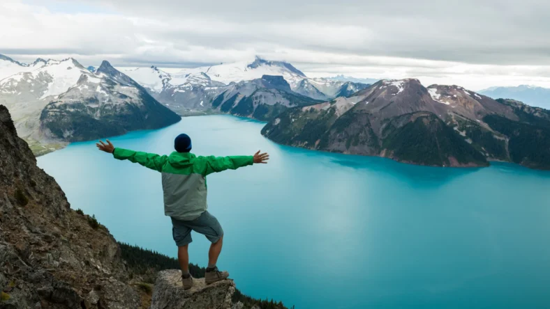 Man outside looking at mountain scene