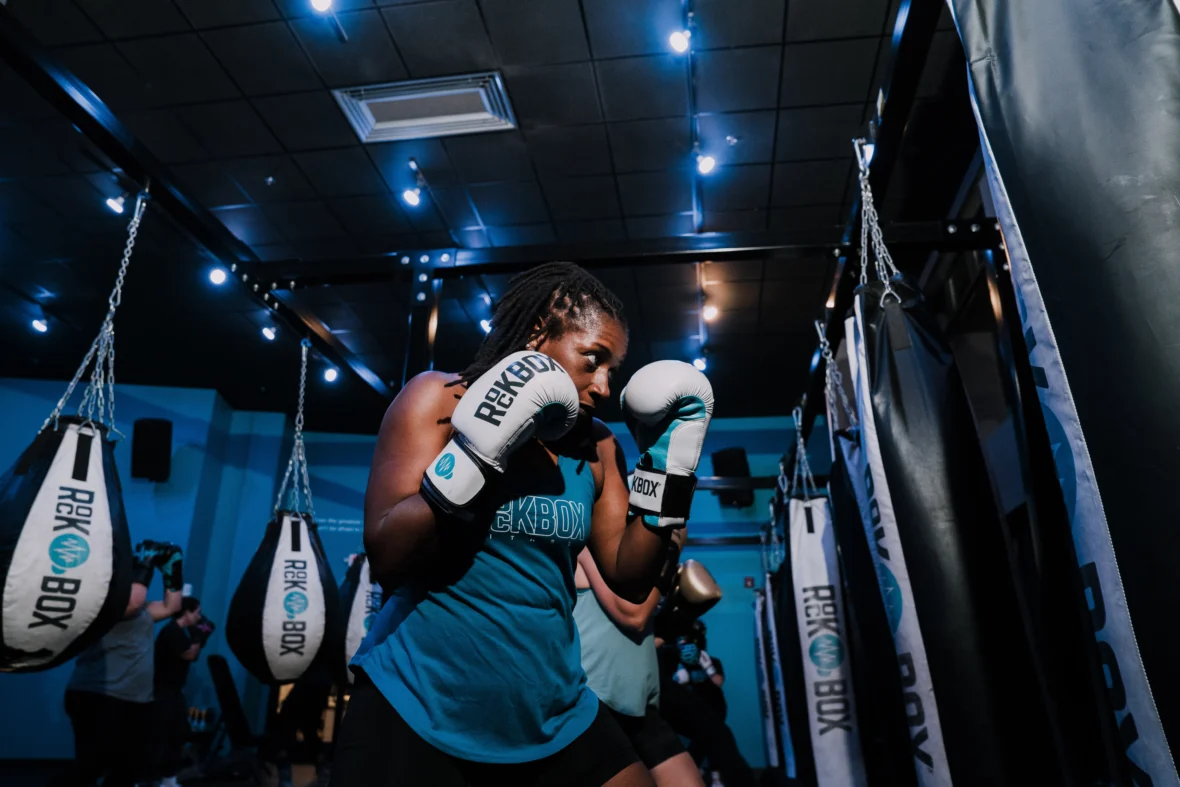 a woman at RockBox fitness with boxing gloves