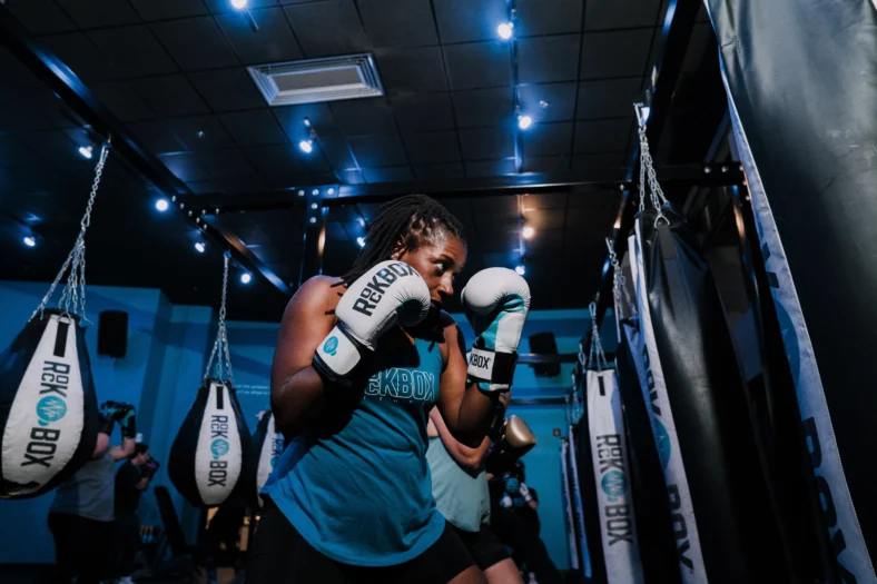 a woman at RockBox fitness with boxing gloves