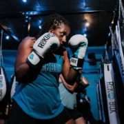a woman at RockBox fitness with boxing gloves