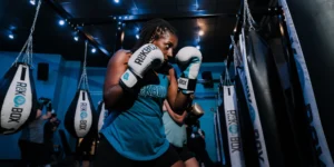 a woman at RockBox fitness with boxing gloves