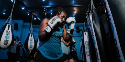 a woman at RockBox fitness with boxing gloves