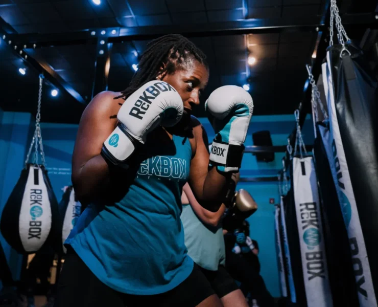 a woman at RockBox fitness with boxing gloves