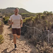 man runs on the beach wearing Sodo Athletic Lab clothes