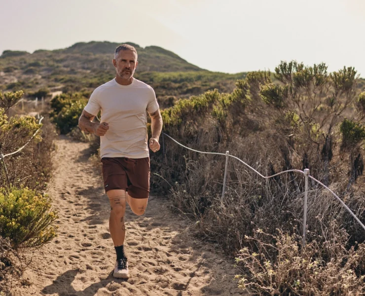 man runs on the beach wearing Sodo Athletic Lab clothes