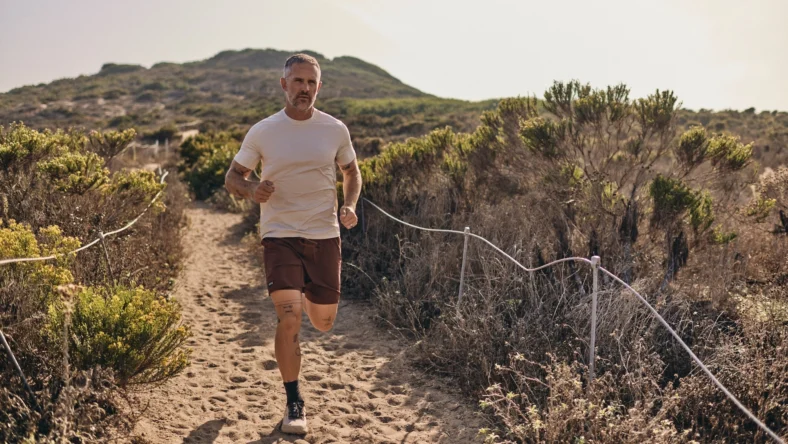 man runs on the beach wearing Sodo Athletic Lab clothes