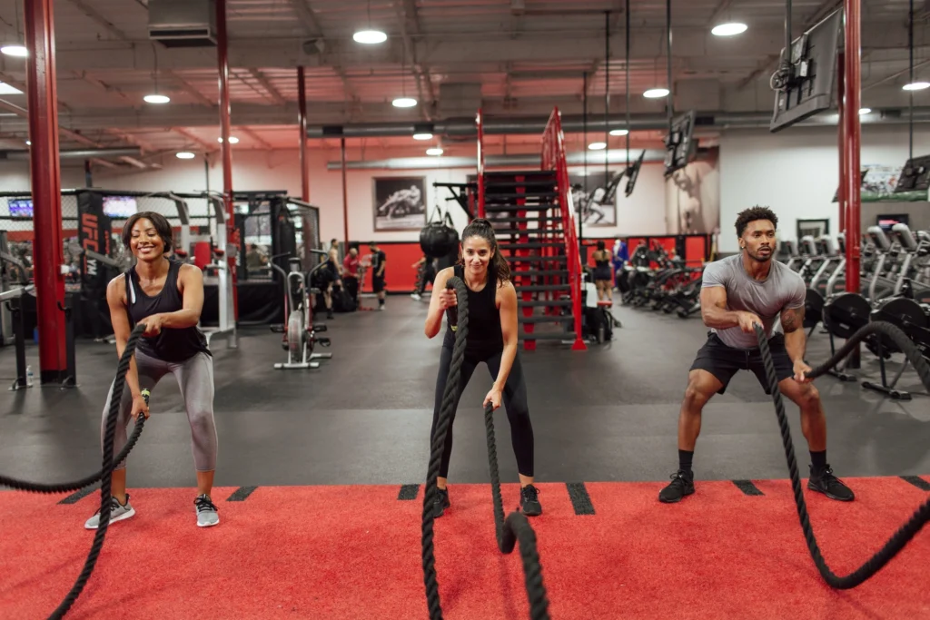 people working out at UFC Gym with ropes