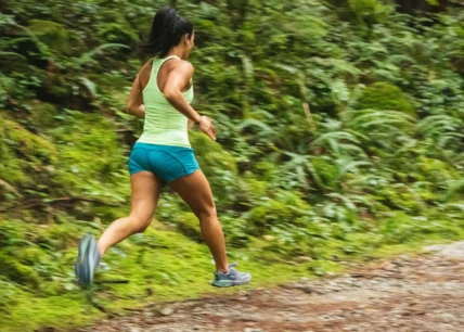 a woman running alone on a trail outdoors