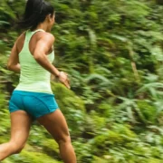 a woman running alone on a trail outdoors