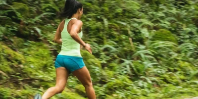 a woman running alone on a trail outdoors