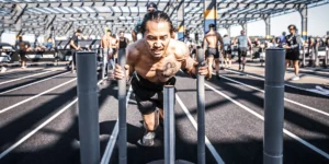 man pushes a sled at a Hyrox race