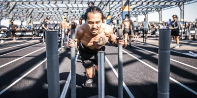 man pushes a sled at a Hyrox race