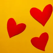 paper hearts on a yellow wall