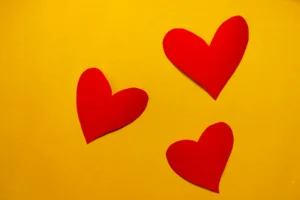 paper hearts on a yellow wall