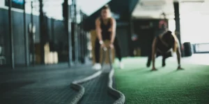 a woman working out with ropes in a gym