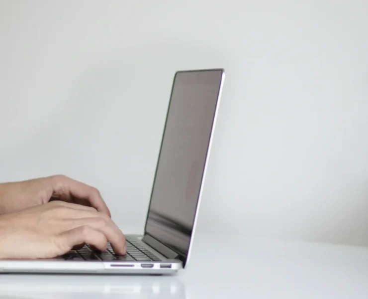 a person typing on a laptop