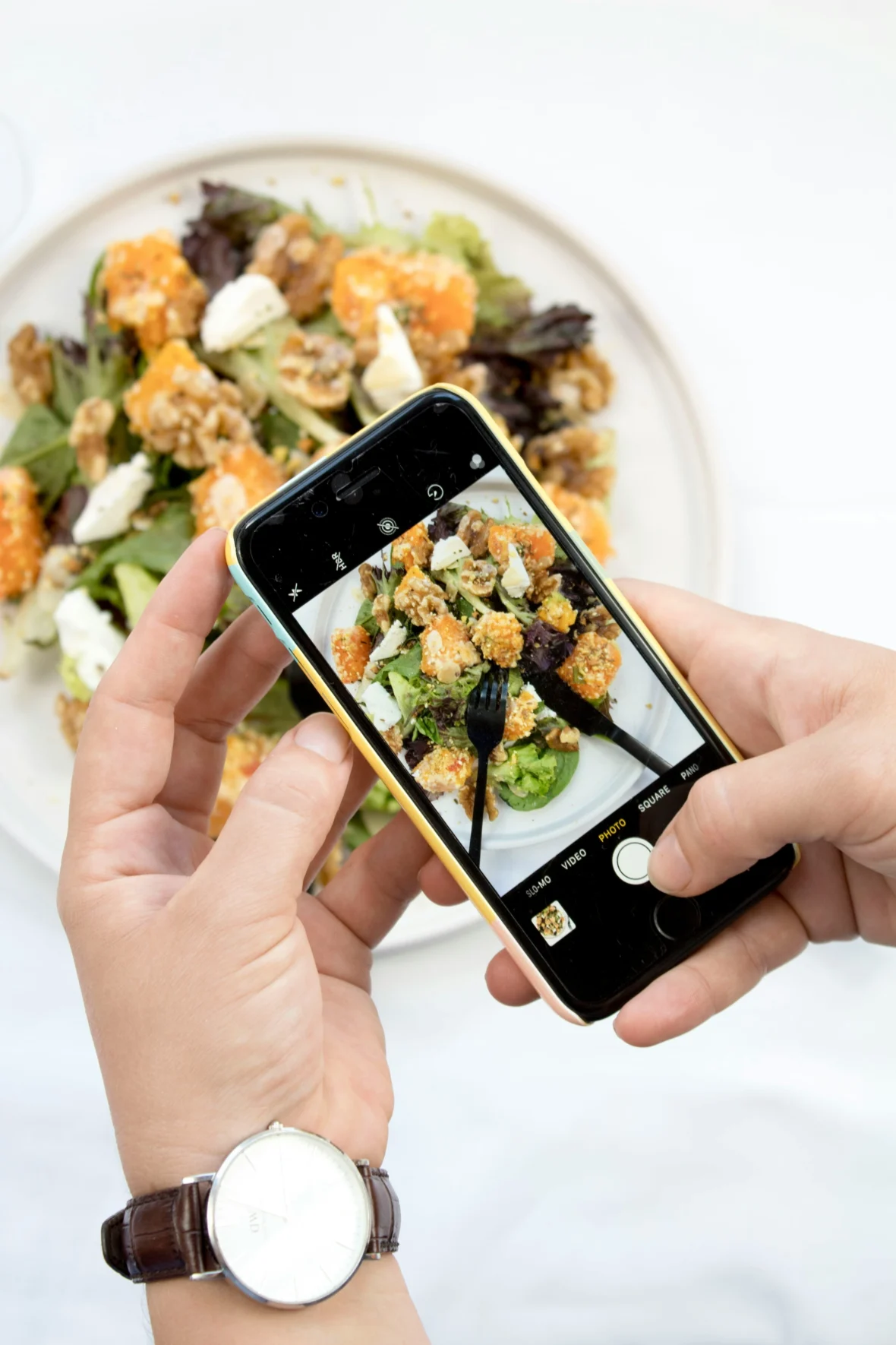 a man taking a photo of his food