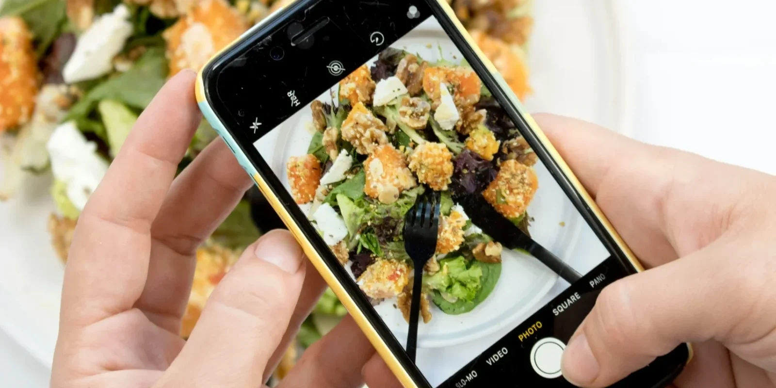 a man taking a photo of his food