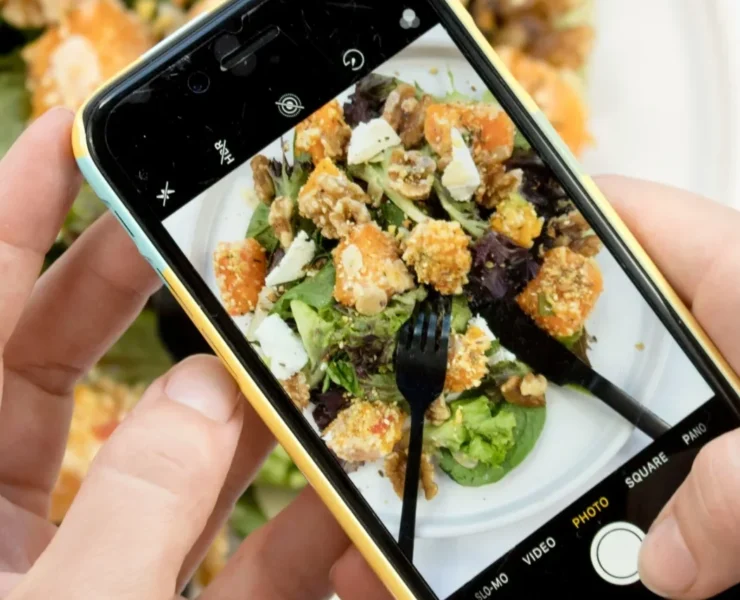 a man taking a photo of his food