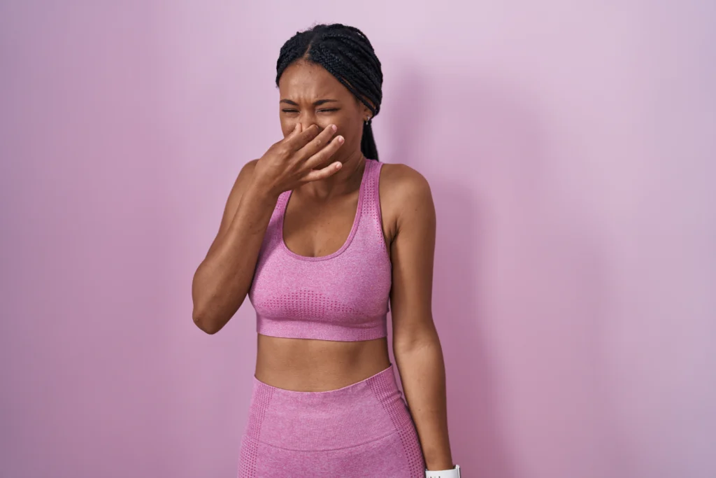 a woman pinching her nose in disgust