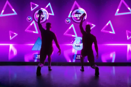 The Lumin Fitness experience; two members in front of immersive screen.