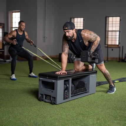 a man using the Fitbench in the gym.