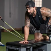 a man using the Fitbench in the gym.