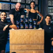 a group shot of people around Bodybuilding.com's supplements.