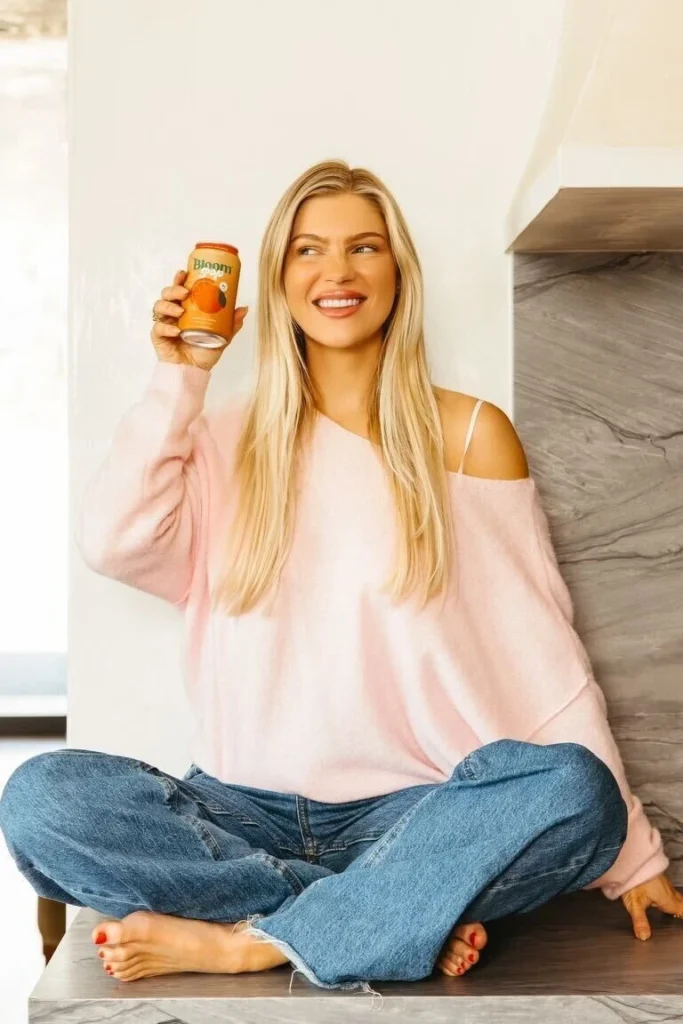 Mari Llewellyn holding a can of Bloom Pop