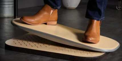 A man wearing nice shoes on an eco-friendly springboard from FluidStance.
