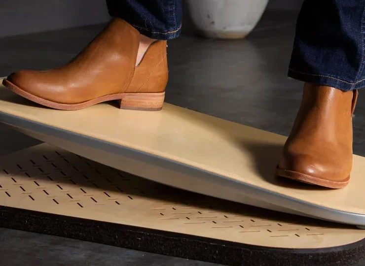 A man wearing nice shoes on an eco-friendly springboard from FluidStance.