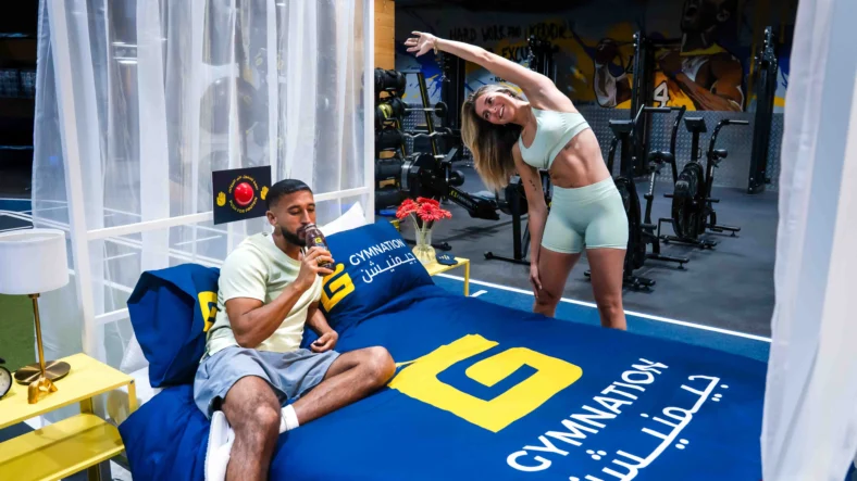 a man and woman staying at GymNation's concept hotel.