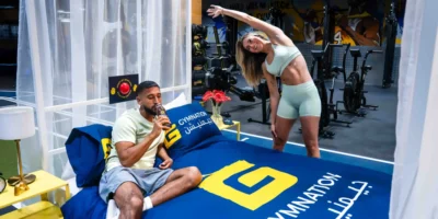 a man and woman staying at GymNation's concept hotel.