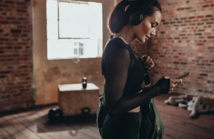 Woman at gym looking at phone