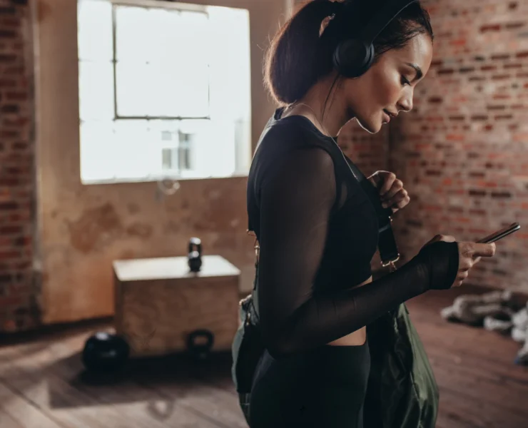 Woman at gym looking at phone