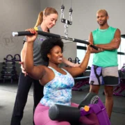 People working out at Planet Fitness with a group trainer.