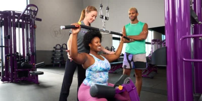 People working out at Planet Fitness with a group trainer.