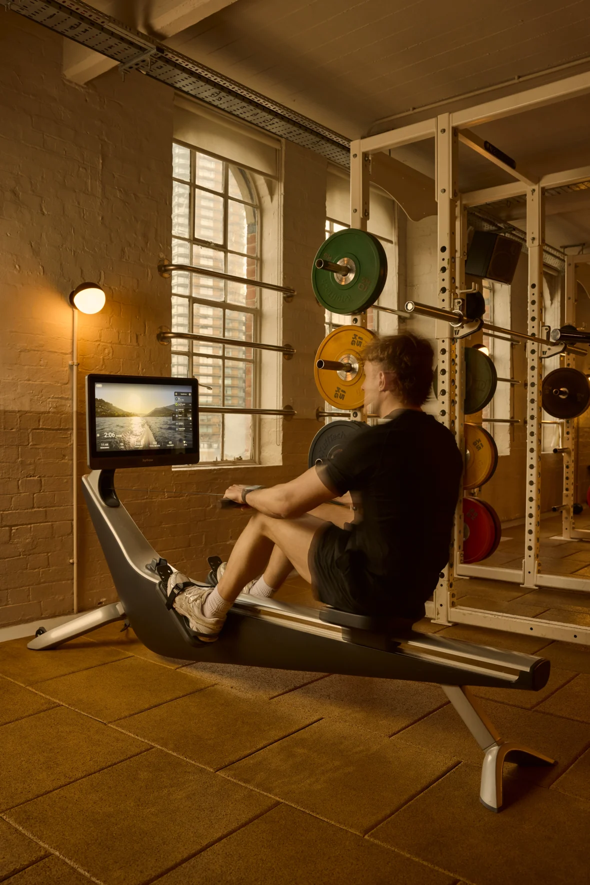 a man working out on a Hydrow at Soho house.