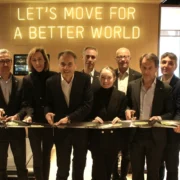 a group shot of Technogym team members cutting a ribbon to their new HQ in NJ.