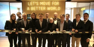 a group shot of Technogym team members cutting a ribbon to their new HQ in NJ.