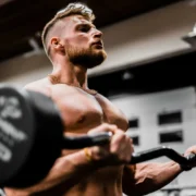 A man in a gym lifting weights.