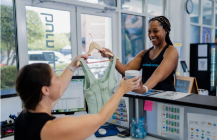Woman at front desk of a fitness studio