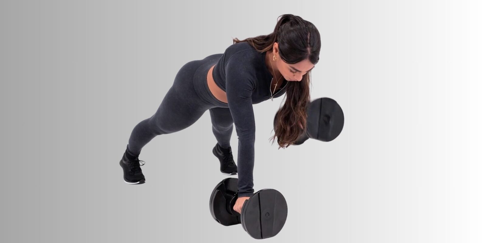 woman using Core Home Fitness dumbbells