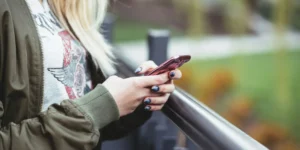 A young woman texting on her phone.