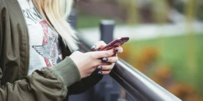 A young woman texting on her phone.
