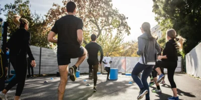 A group fitness class being held outdoors.