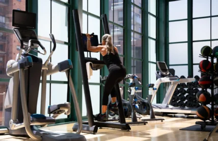 woman on climbing machine in gym