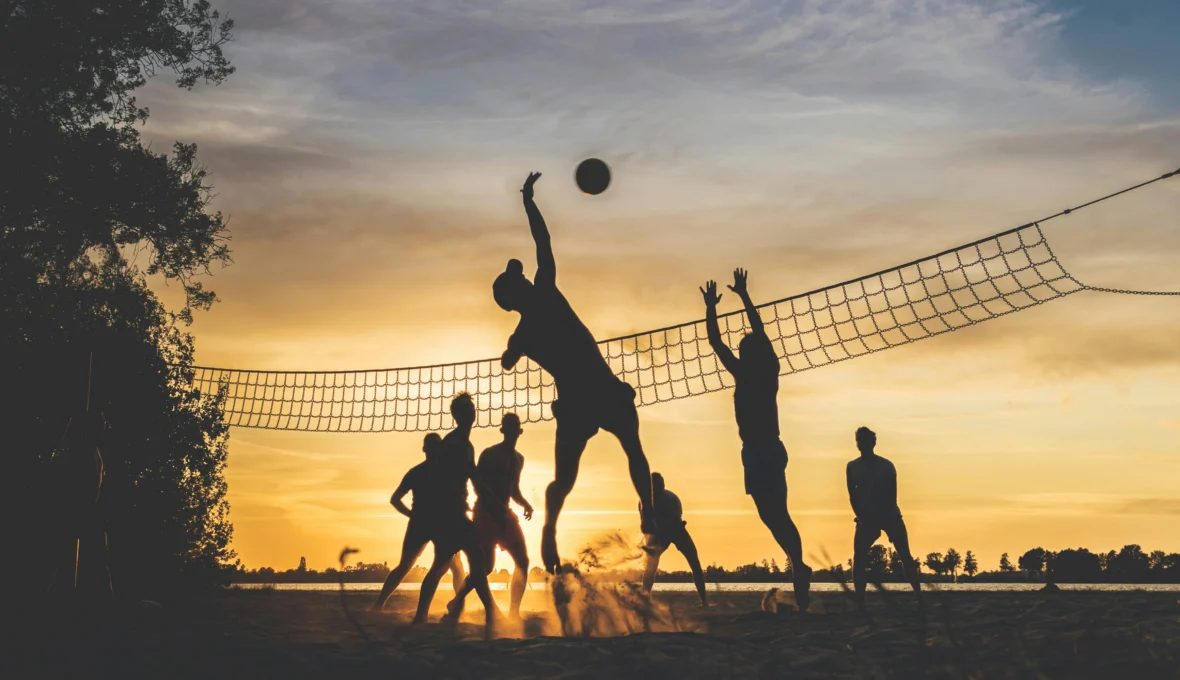 A group of fitness enthusiasts/sports fans playing volleyball.